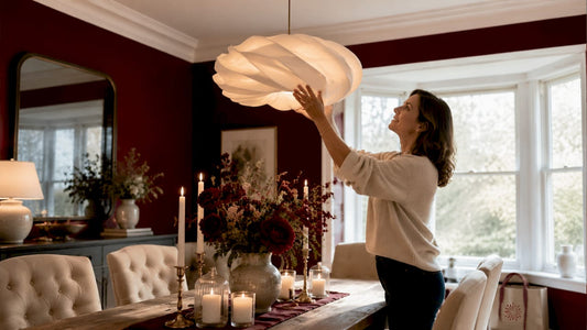 Woman adjusting luxury chandelier in living room