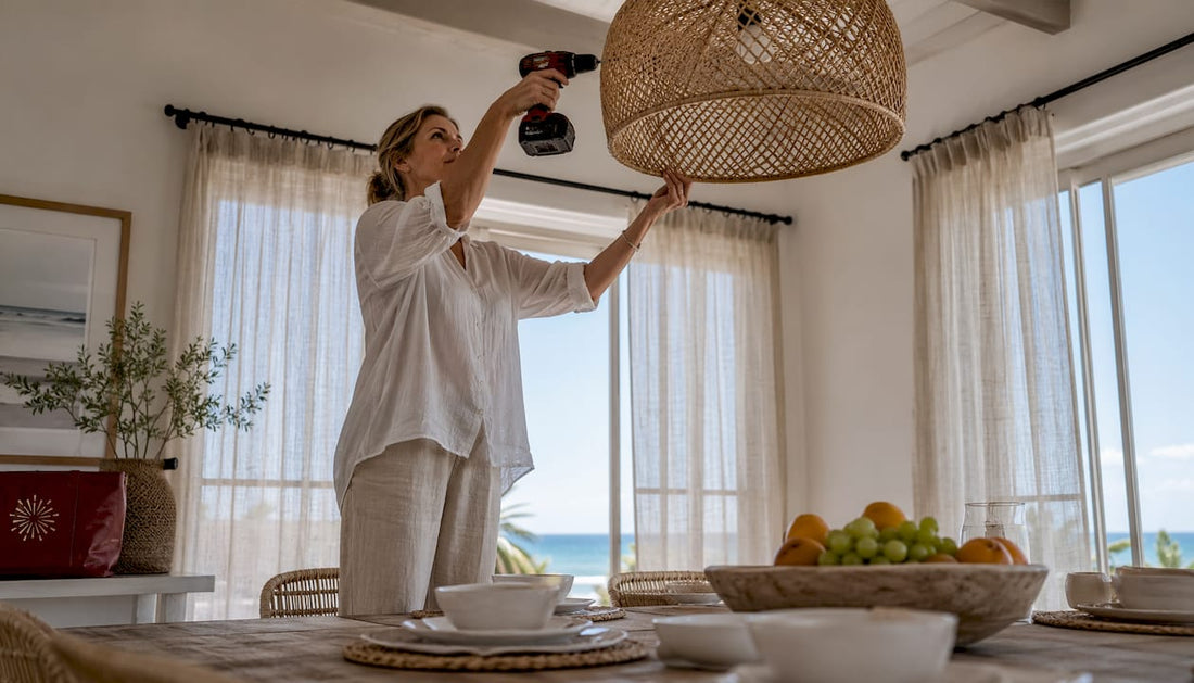 Woman adjusting coastal pendant light indoors