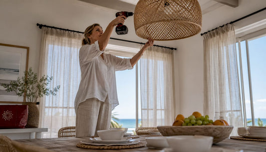 Woman adjusting coastal pendant light indoors