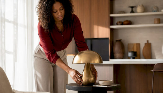 Woman arranging lamp in modern living room