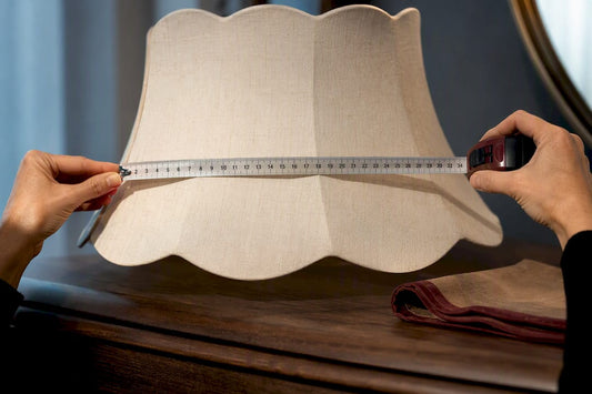 Hands measuring a lampshade's widest point