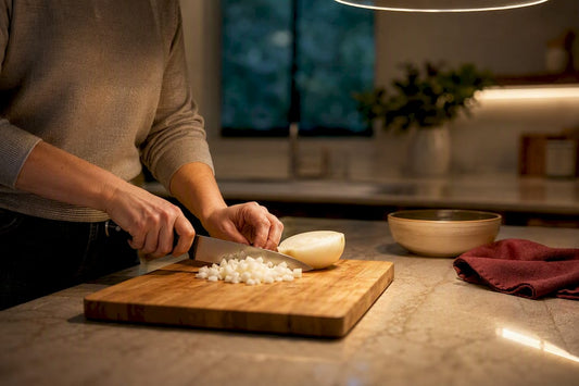 Hands preparing food under warm task lighting