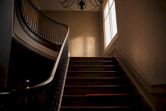 Chandelier silhouette above a double-height stairwell