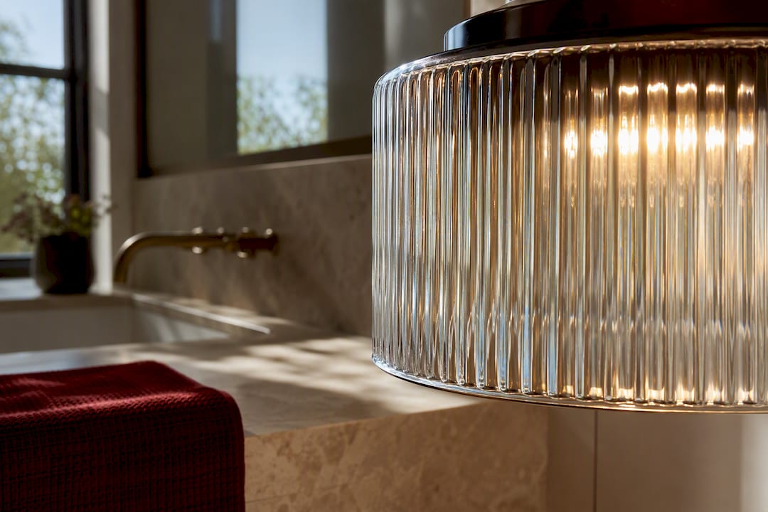 Ribbed glass shade glowing in warm interior