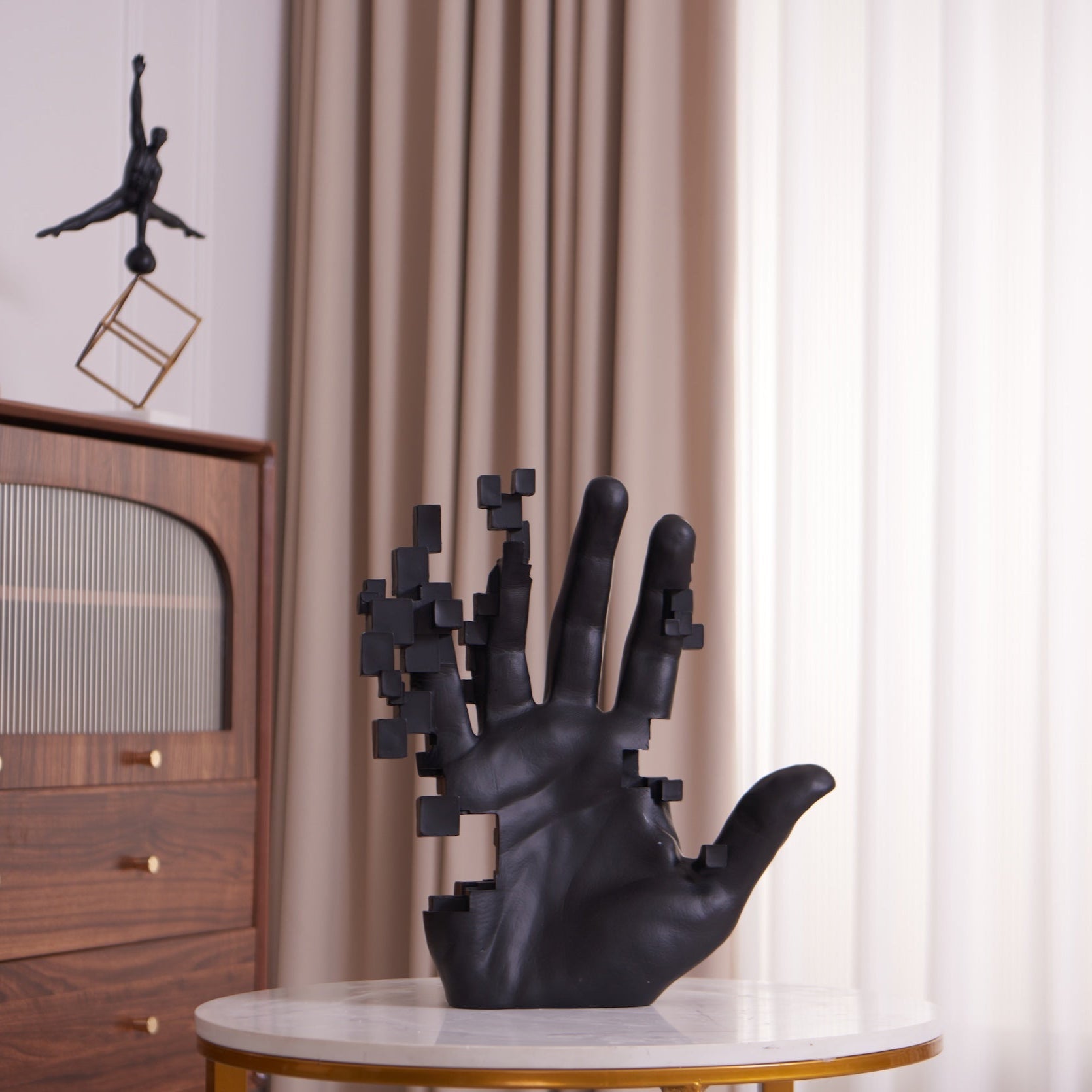 Matte black resin sculpture of pixelated hand