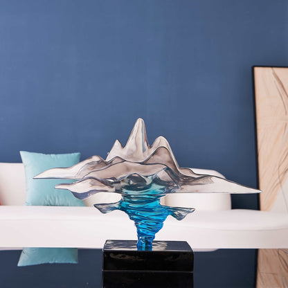 Clear gray and blue resin sculpture with swirling abstract design
